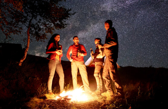 Friends roasting marshmallows around firepit in Prescott